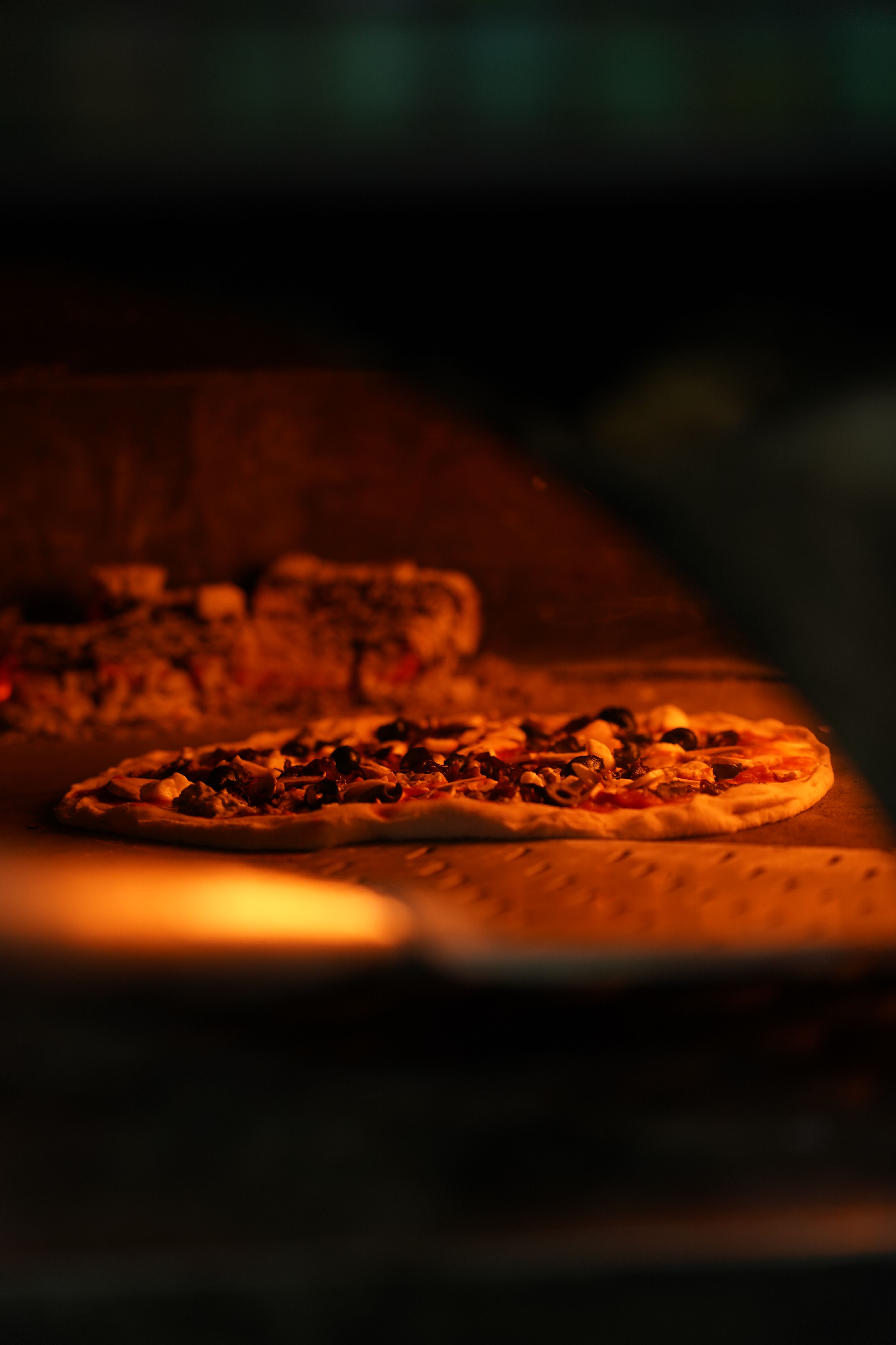 Hands stretching pizza dough on a floured surface